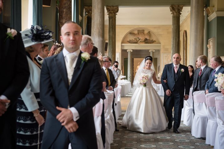 Bride walking down the aisle at The Sculpture Gallery, Woburn Abbey