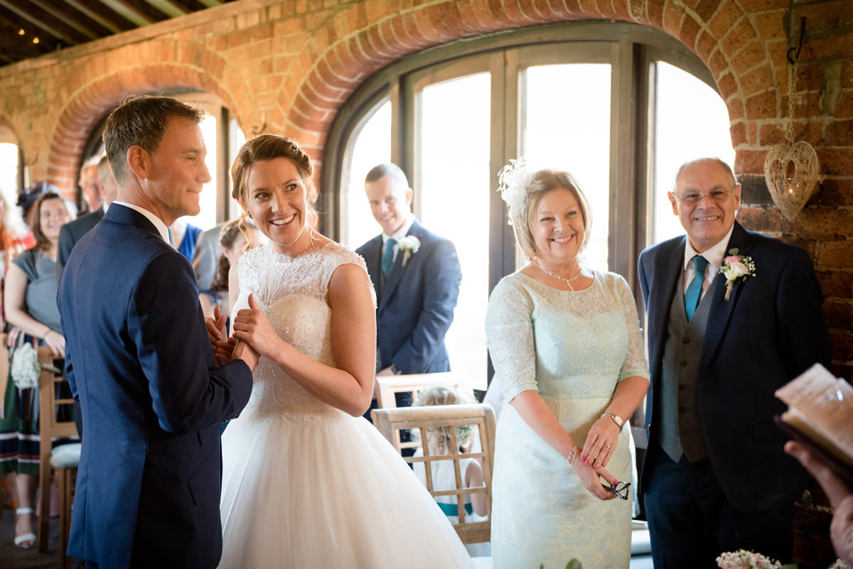 Bride & Groom smiling during their wedding ceremony at Dodmoor House