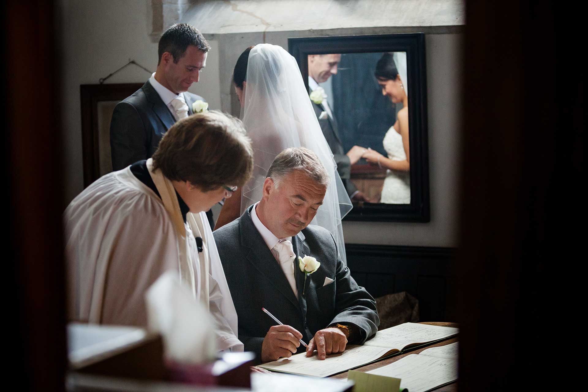 Father of the bride signing the register