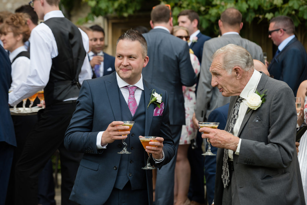 Guests drinking pimms during the drinks reception at Notley Abbey