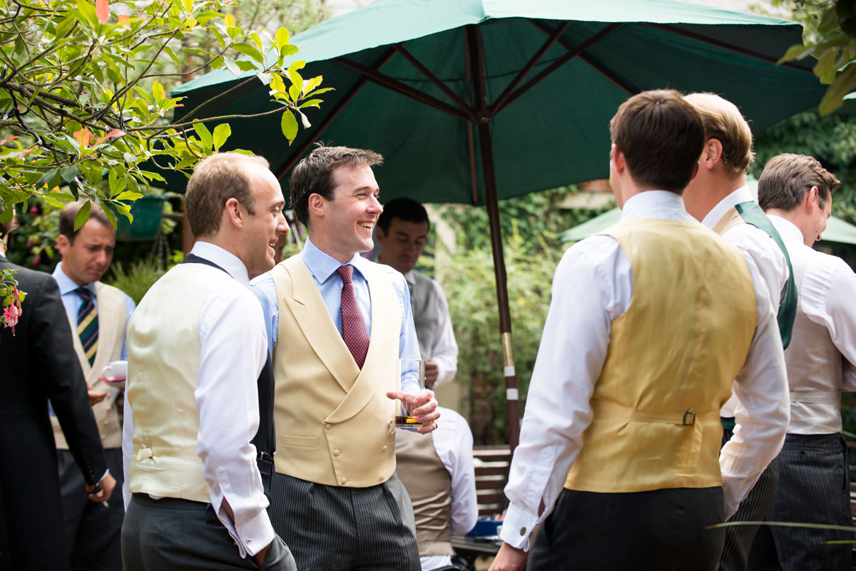 Groom laughing with his Groomsmen at the pub in Great Brington