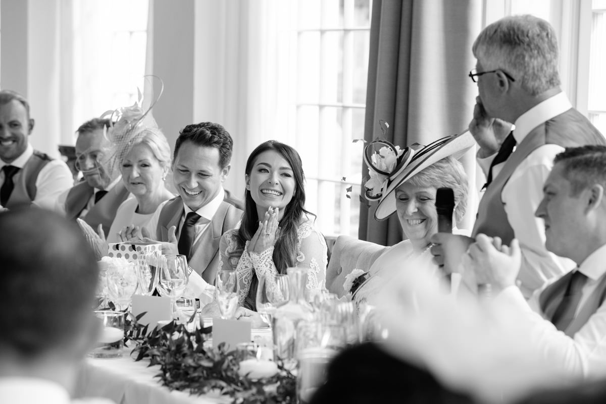 Bride looking adoringly at her Dad during his speech at Rushton Hall