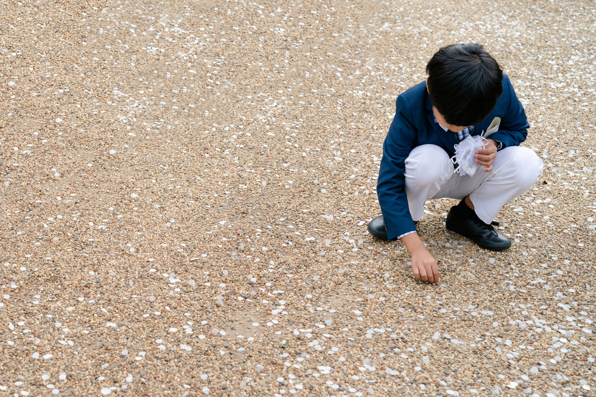 Child picking up confetti at Rushton Hall