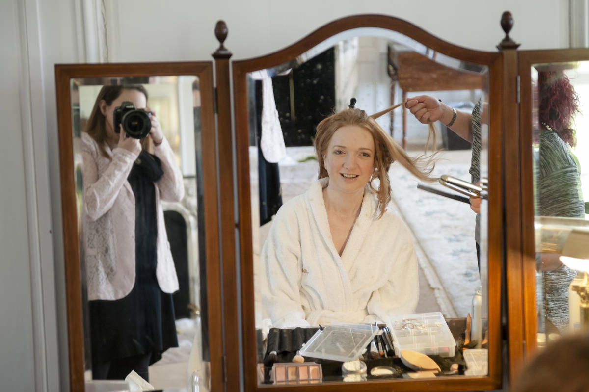Sarah Vivienne photographing a bride having her hair done