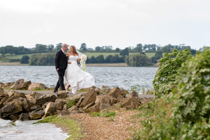 Bride and groom walking arm in arm as they leave Normanton church
