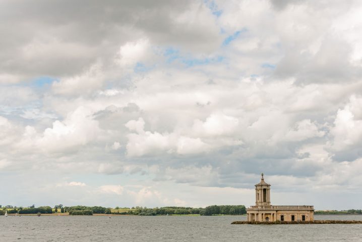 View of Normanton church with a partially cloudy sky and tiny bit of blue sky