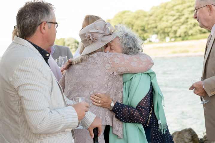 Wedding guest hugging mother of the bride at Normanton Church