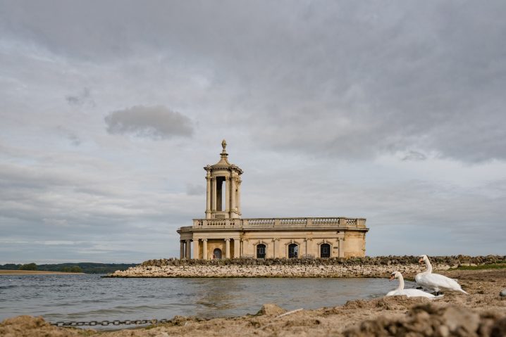 Normanton church with two swans in the foreground