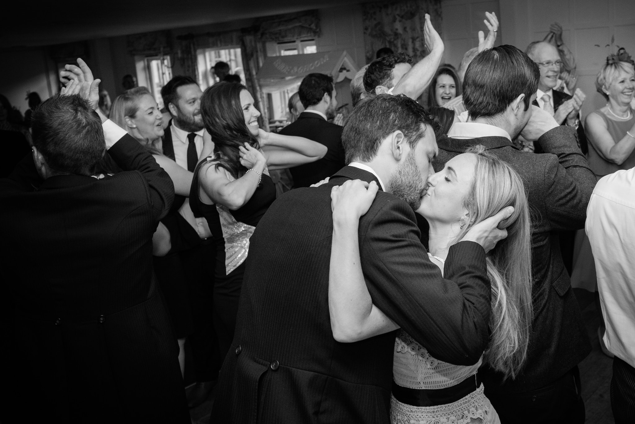 Two wedding guests kissing during first dance