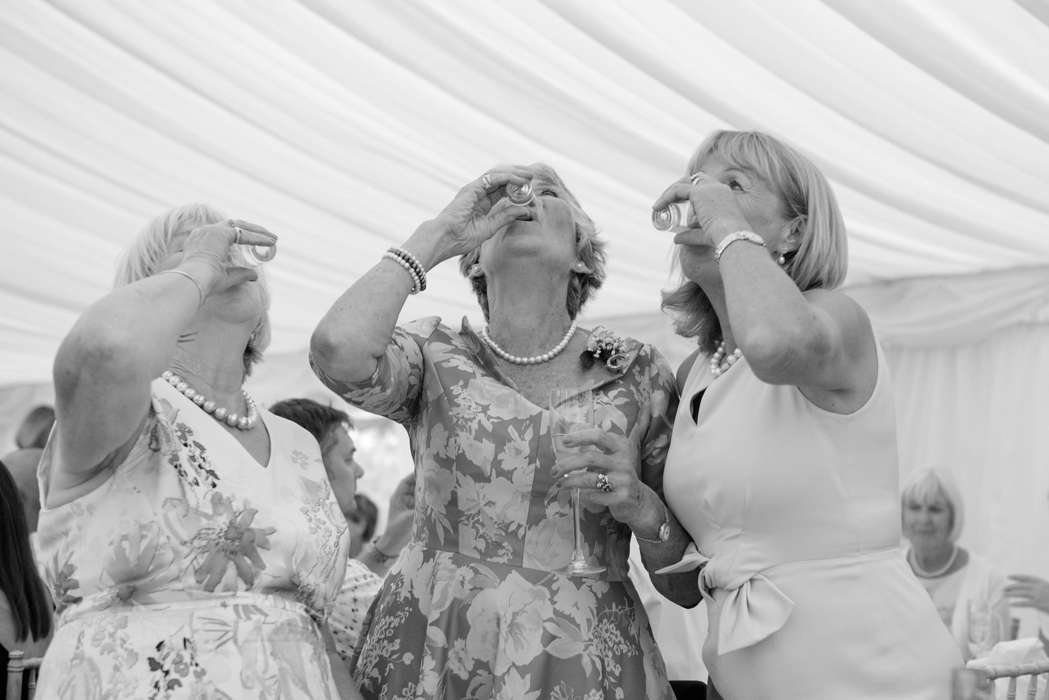 Mothers of the bride and groom drinking shots