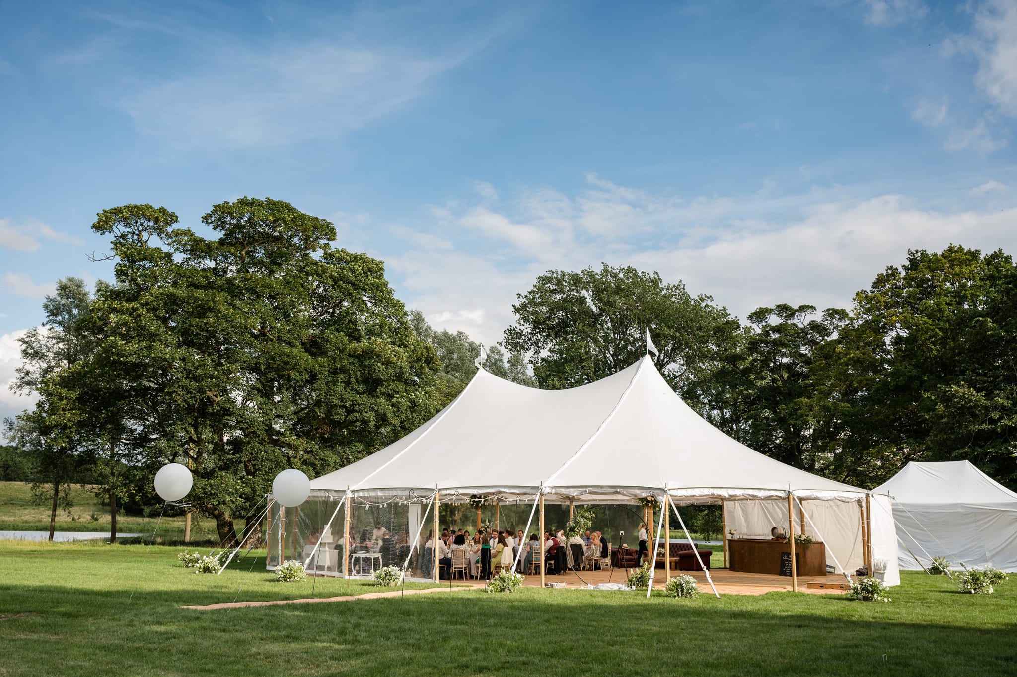 Sailcloth wedding marquee by the lakside at Deene Park