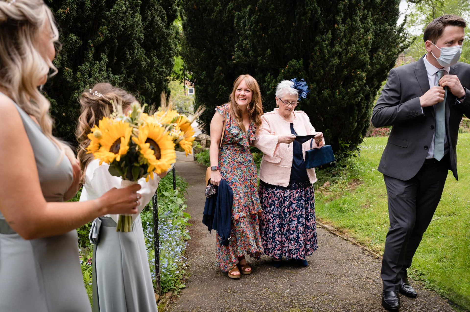 Wedding guests arriving at Dallington church