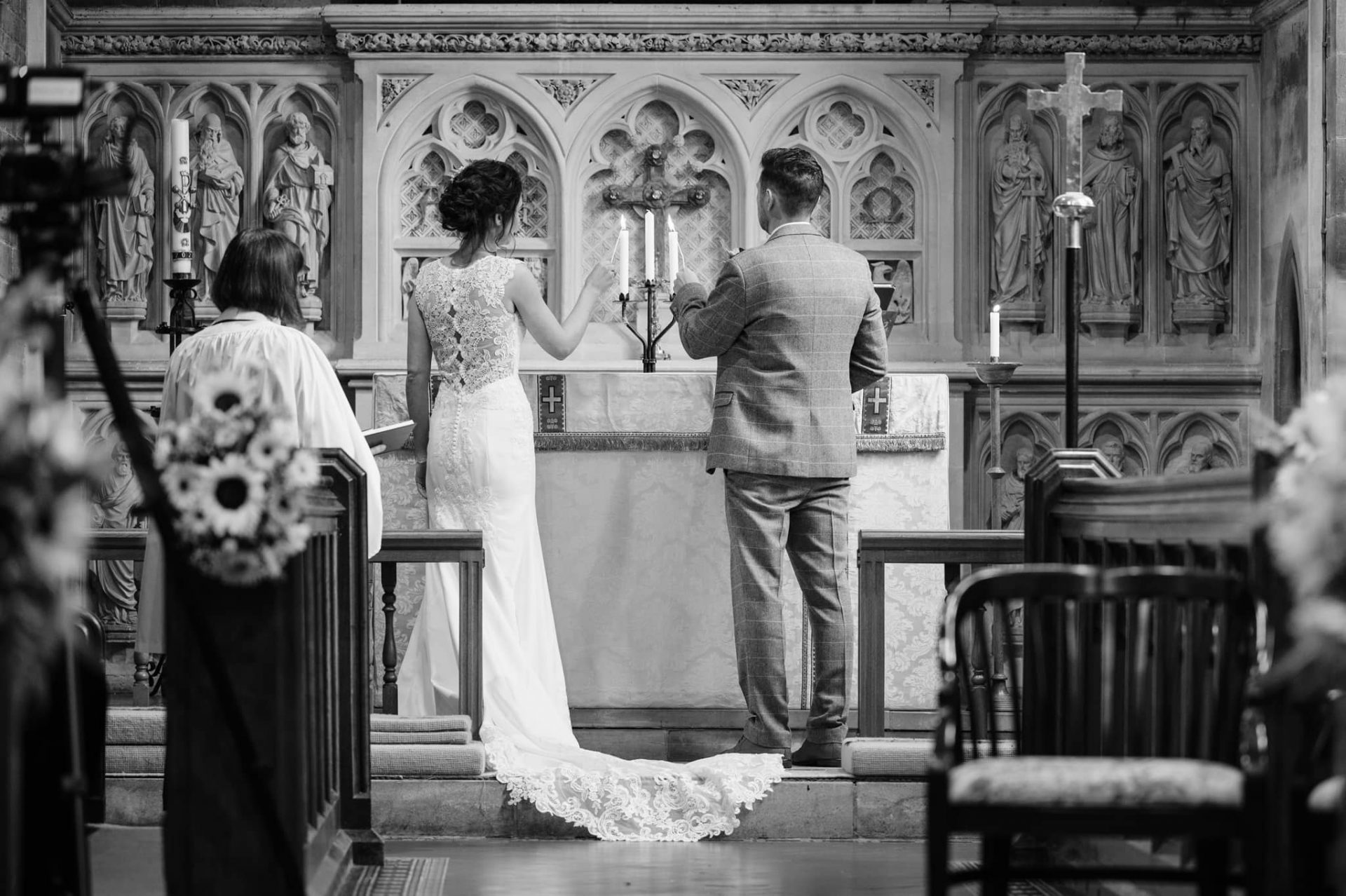 Bride and groom lighting a unity candle at Dallington church