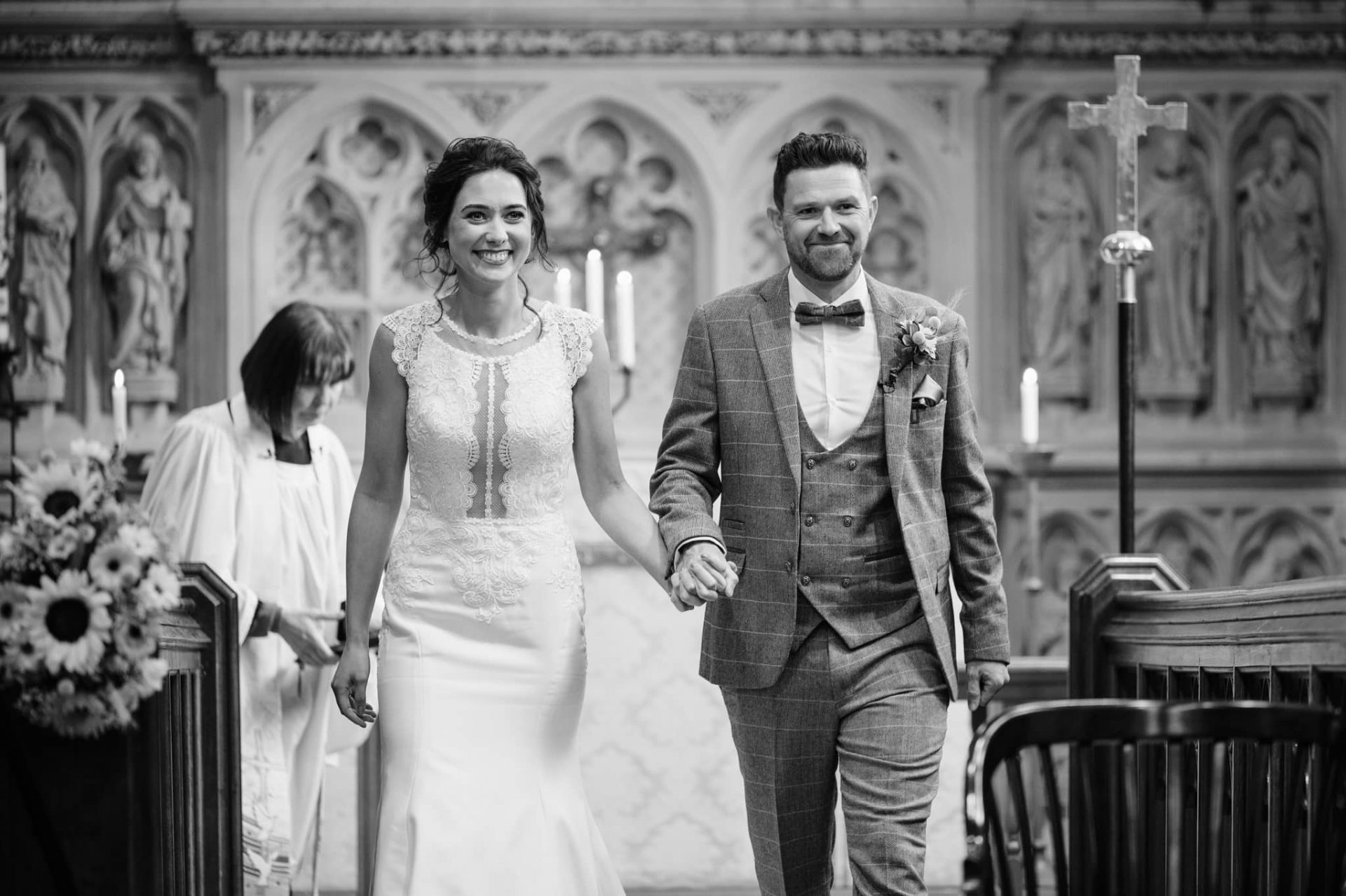 Bride and groom walking down the aisle at Dallington church