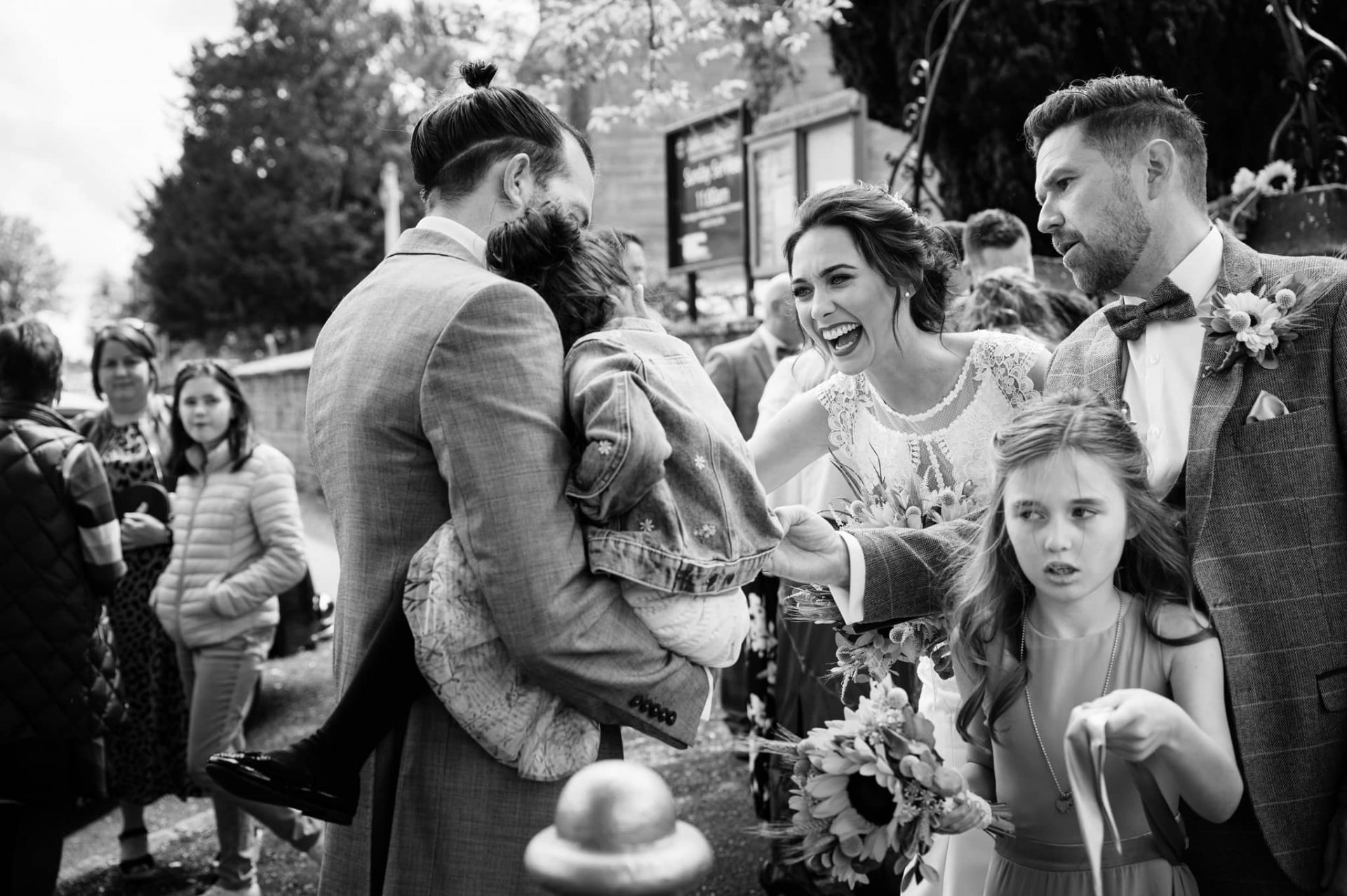 Bride and groom greeting friends outside Dallington church