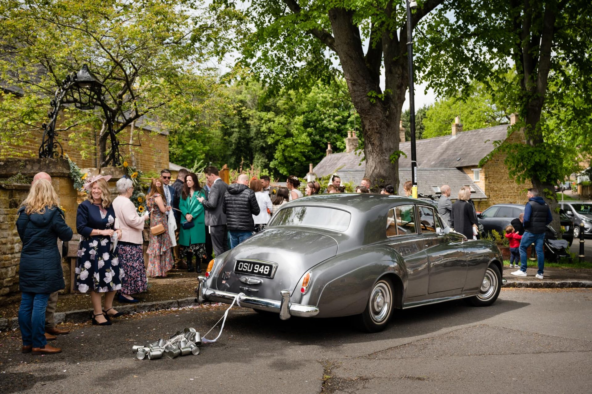 Vintage wedding with tin cans outside Dallington church