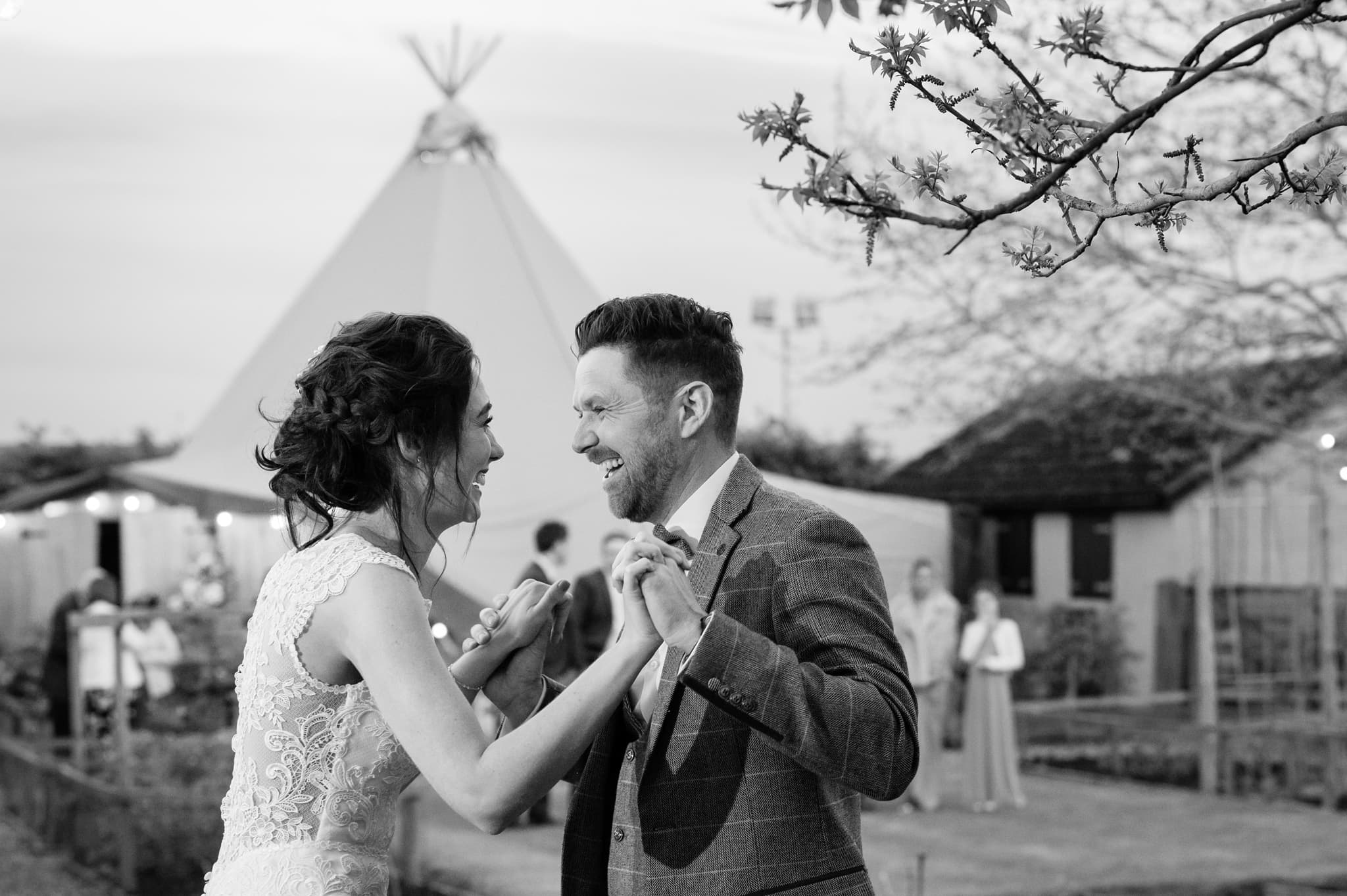 Outside first dance in front of a wedding tipi