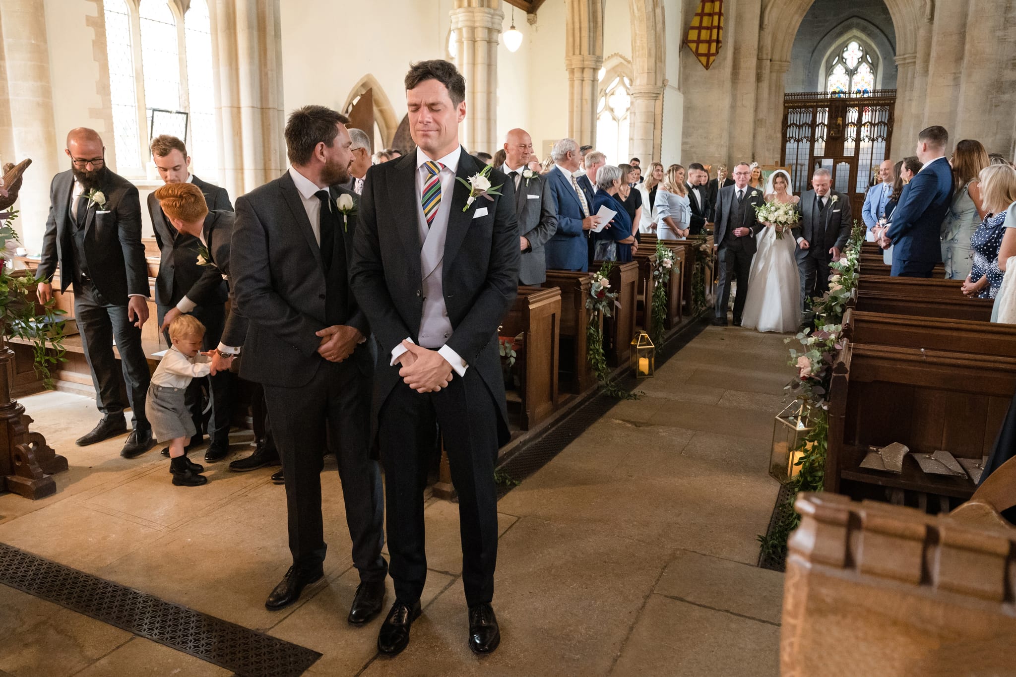 Groom looking emotional as bride walks down aisle