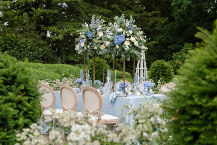 Pale blue table linen and flowers on an outdoor table