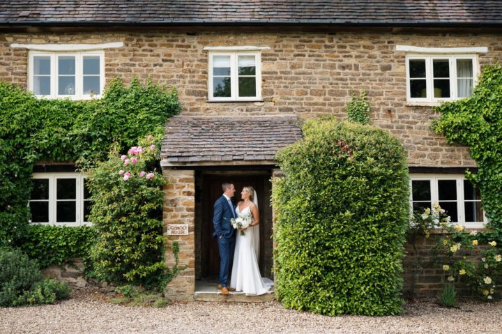 Bride & groom in front of Dodmoor House