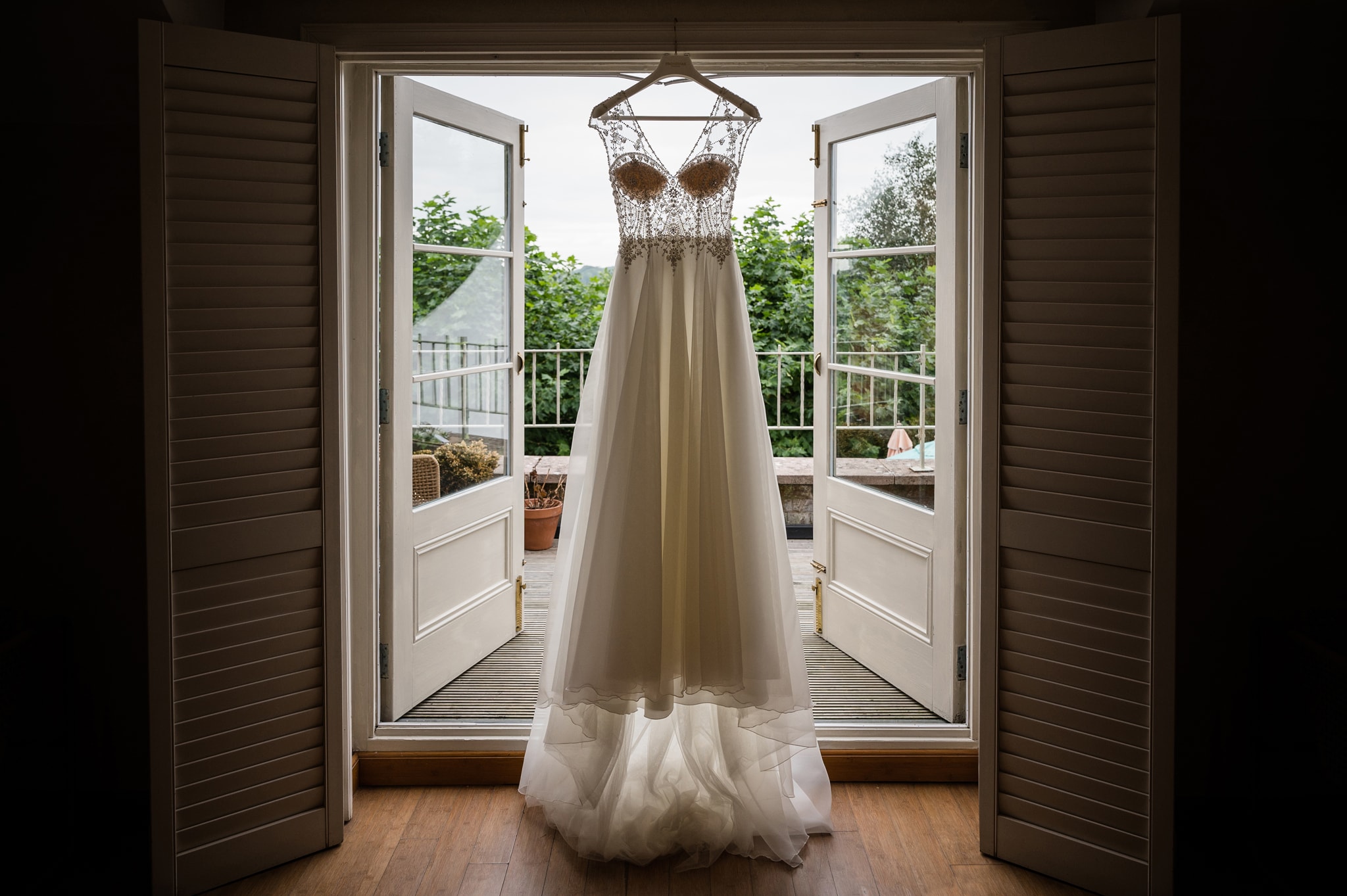 Wedding dress hanging on balcony window