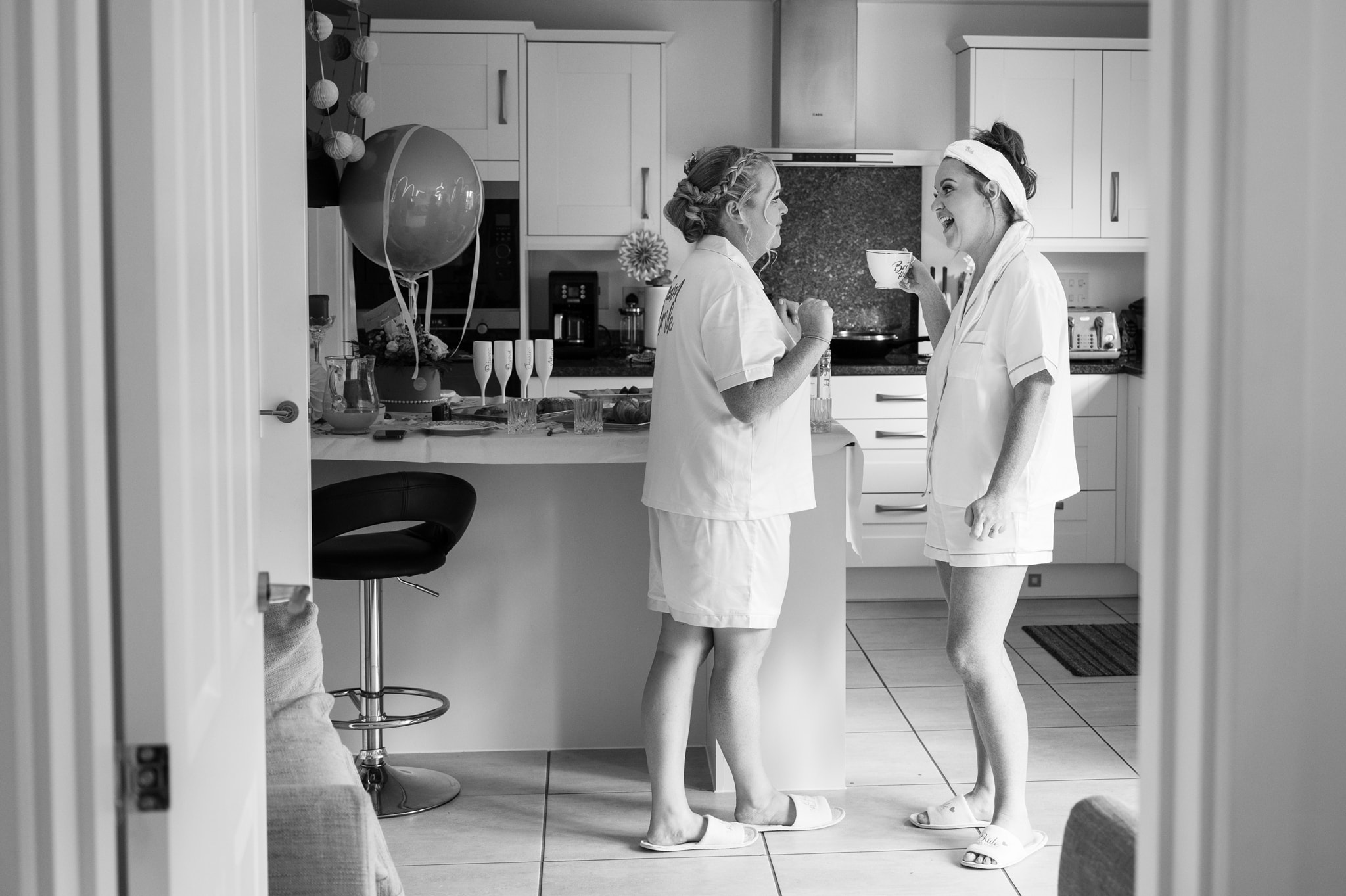 Bride and sister chatting in kitchen