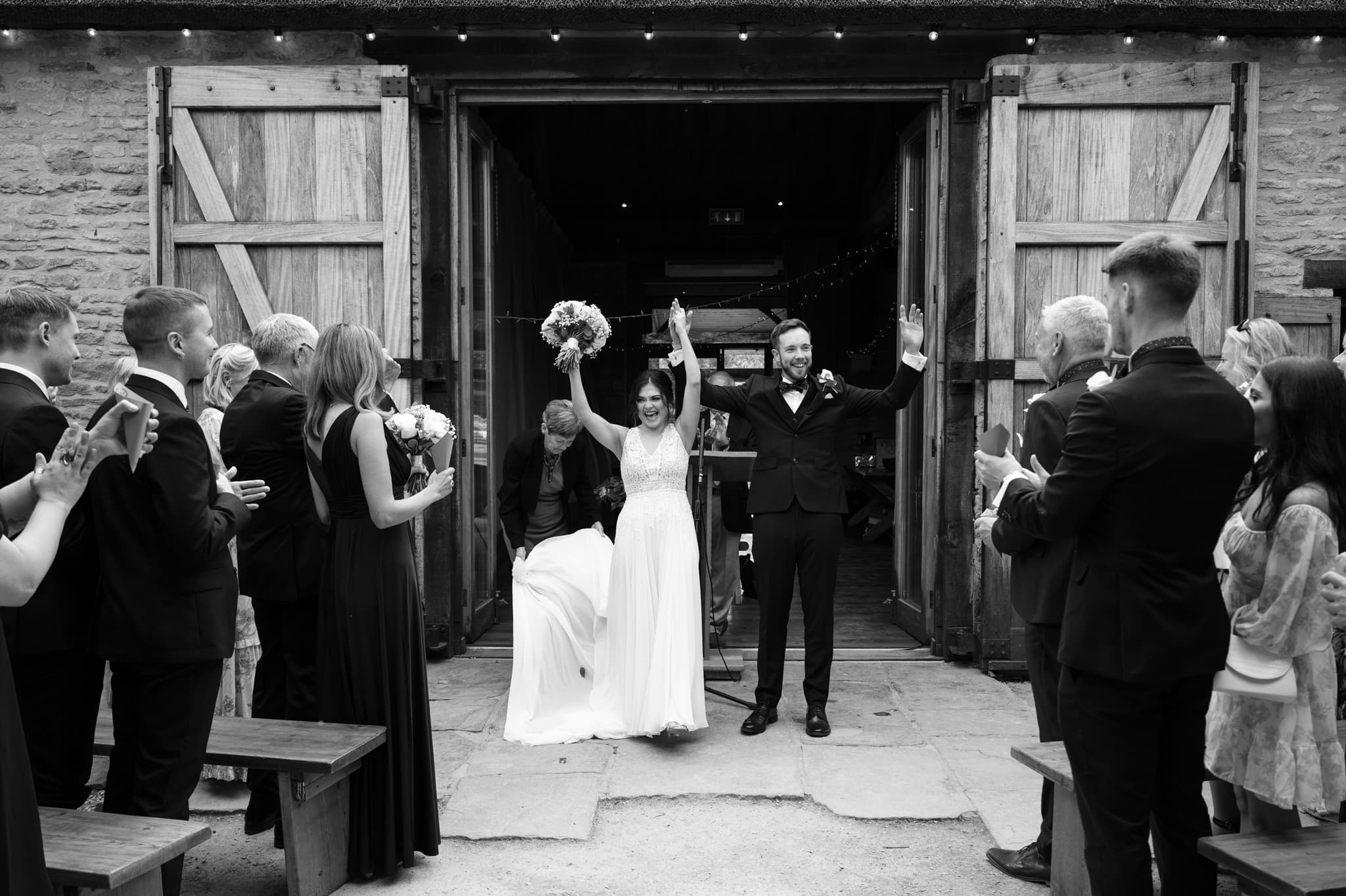 Bride and groom cheering before they walk down the aisle