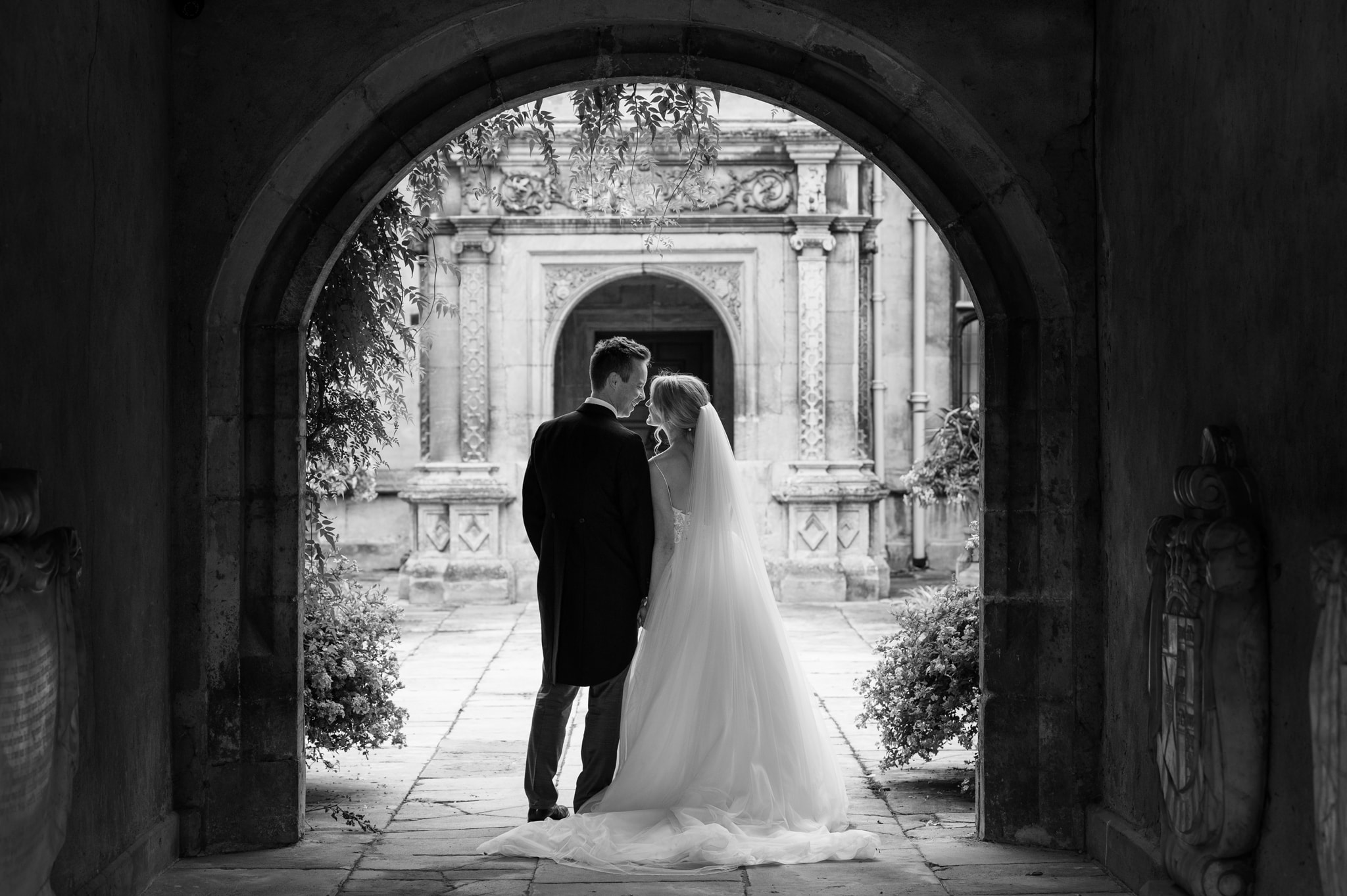 Bride and groom underneath an arch
