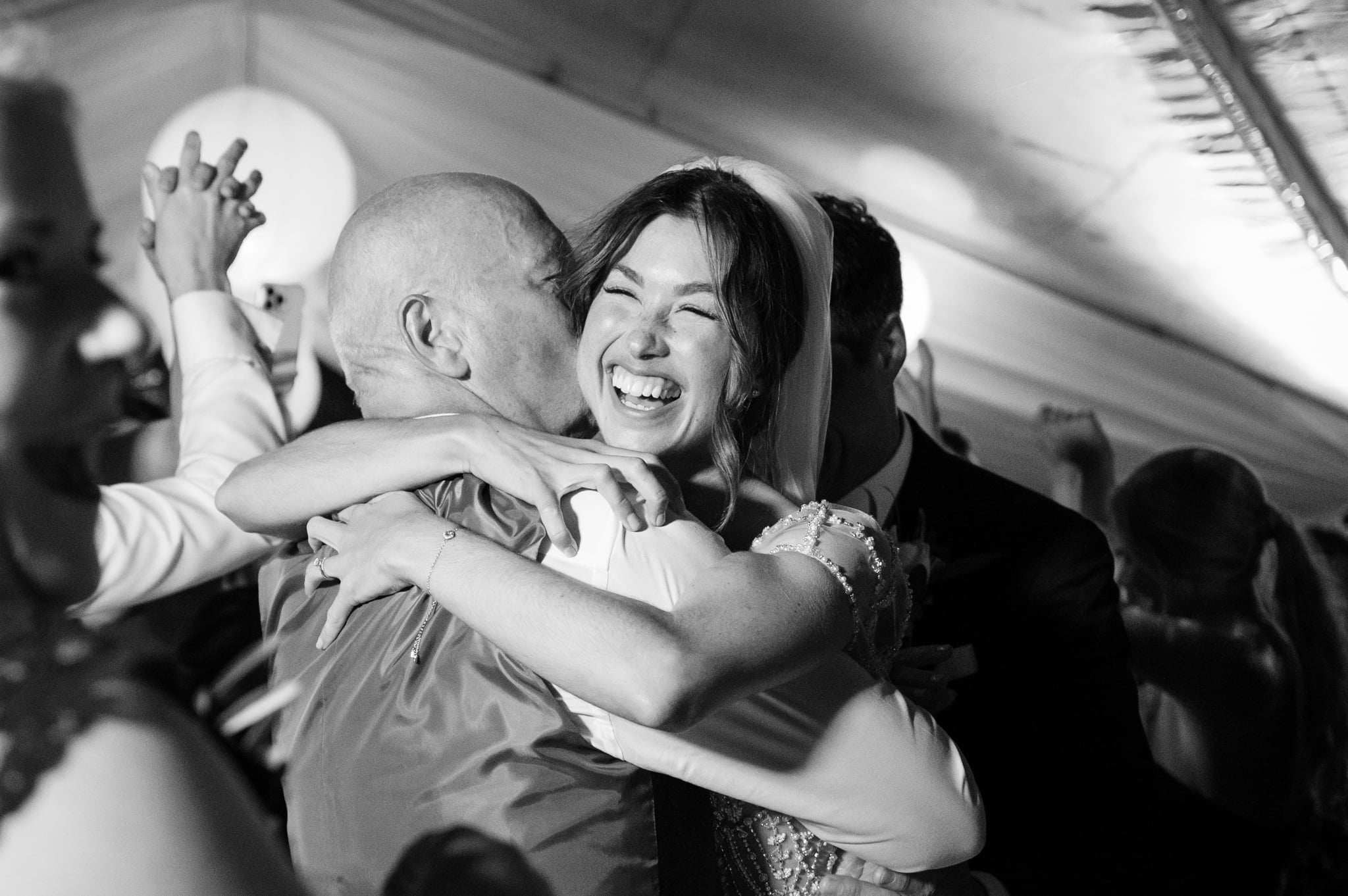 Bride hugging her dad tightly on the dancefloor