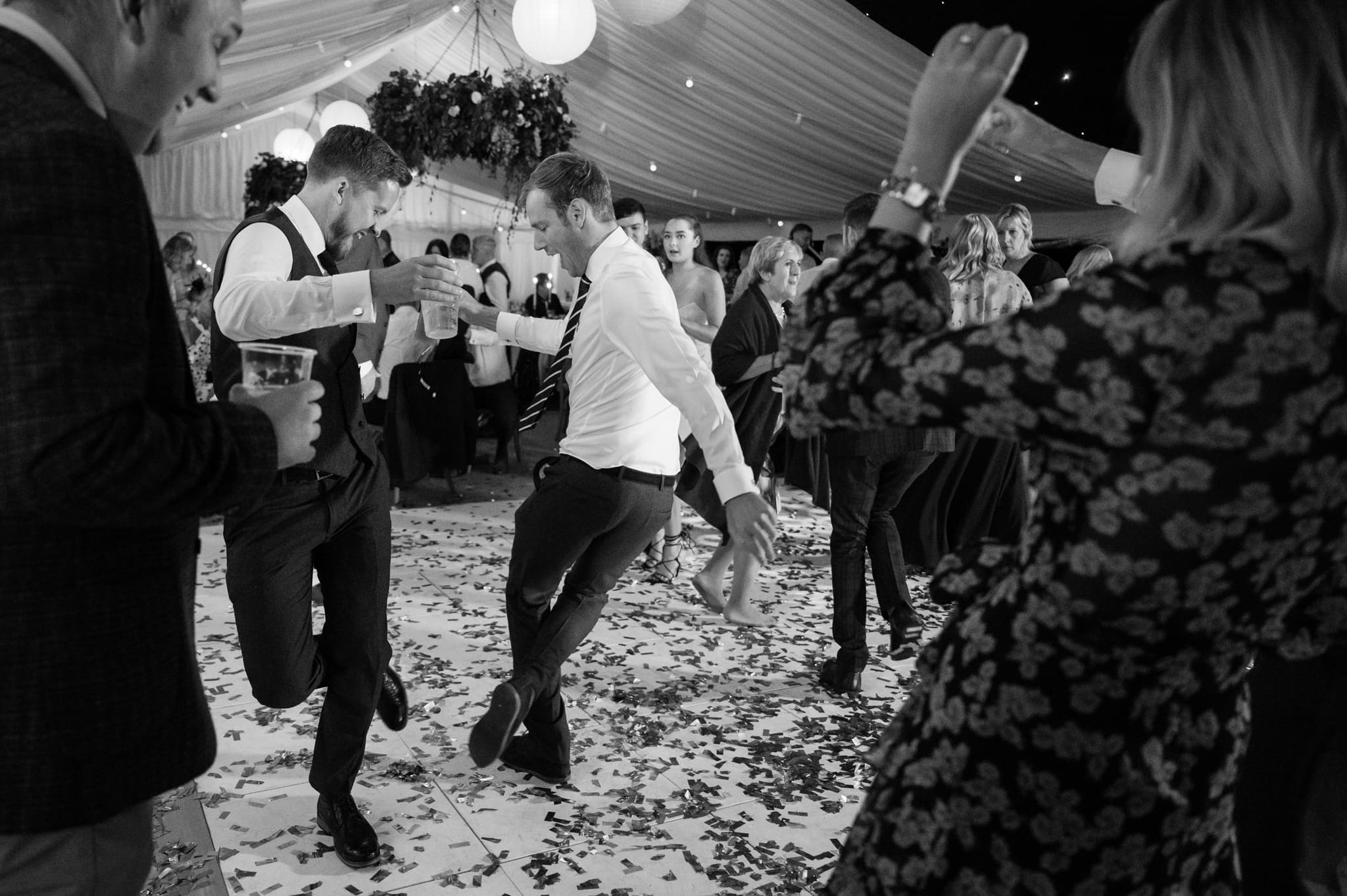Two wedding guests throwing shapes on the dancefloor