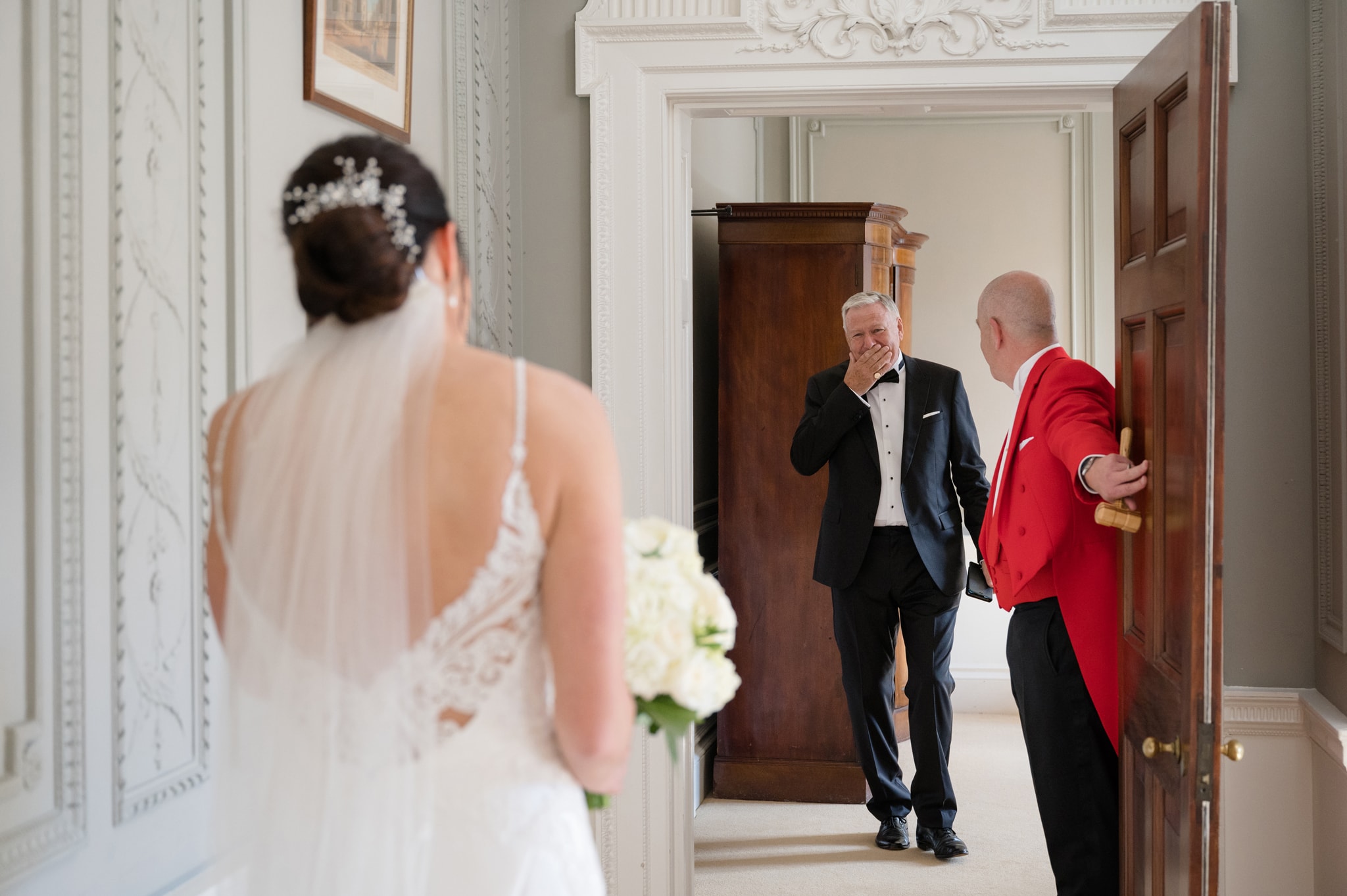 Bride's Dad holding his hand to his mouth in disbelief as he sees bride in her wedding dress for first time