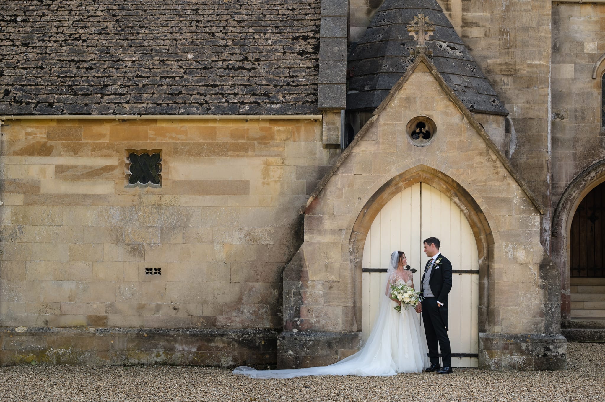 Bride and groom in front of Exton Park chapel