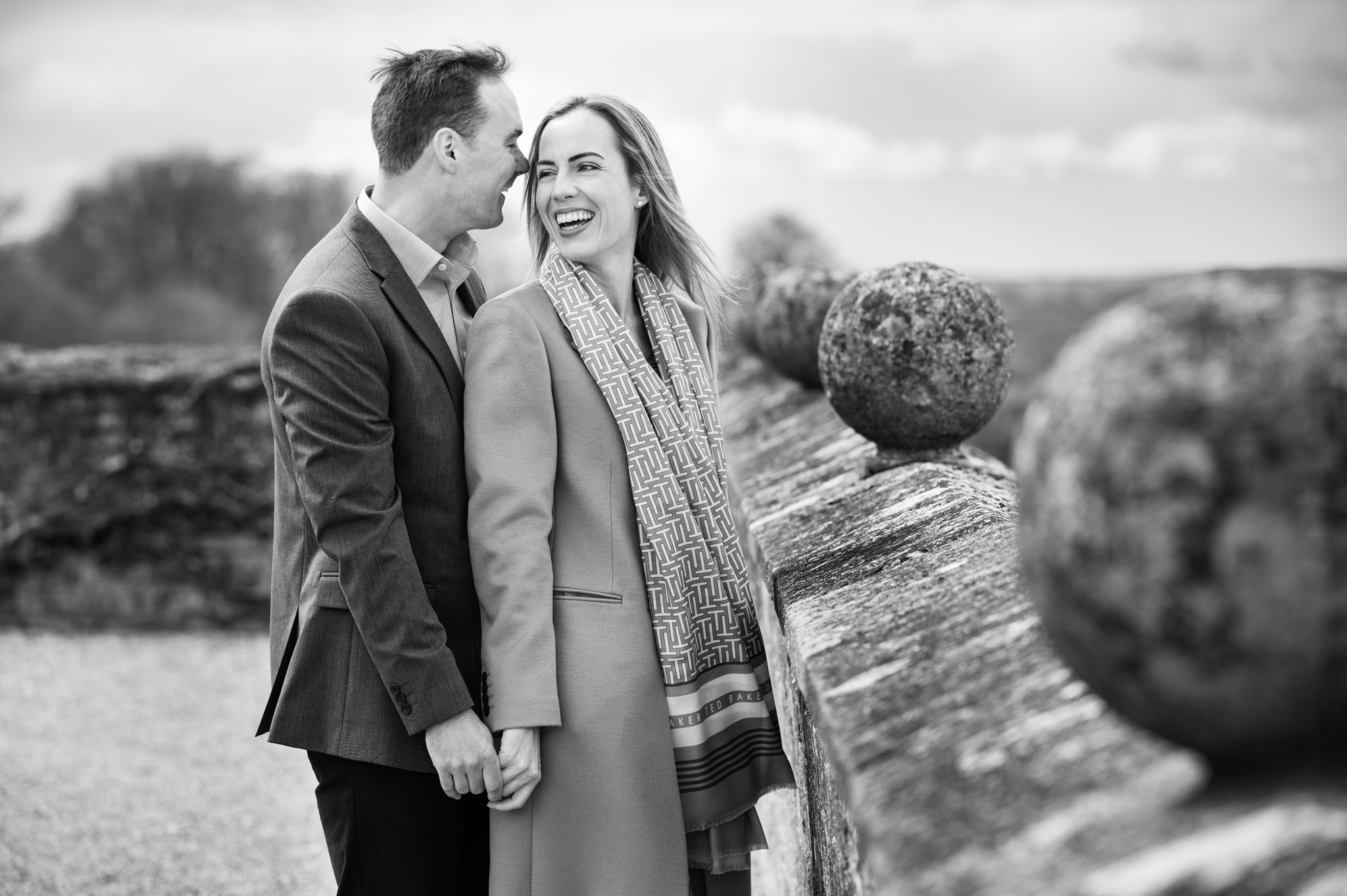Couple laughing together on the ramparts at Rockingham Castle