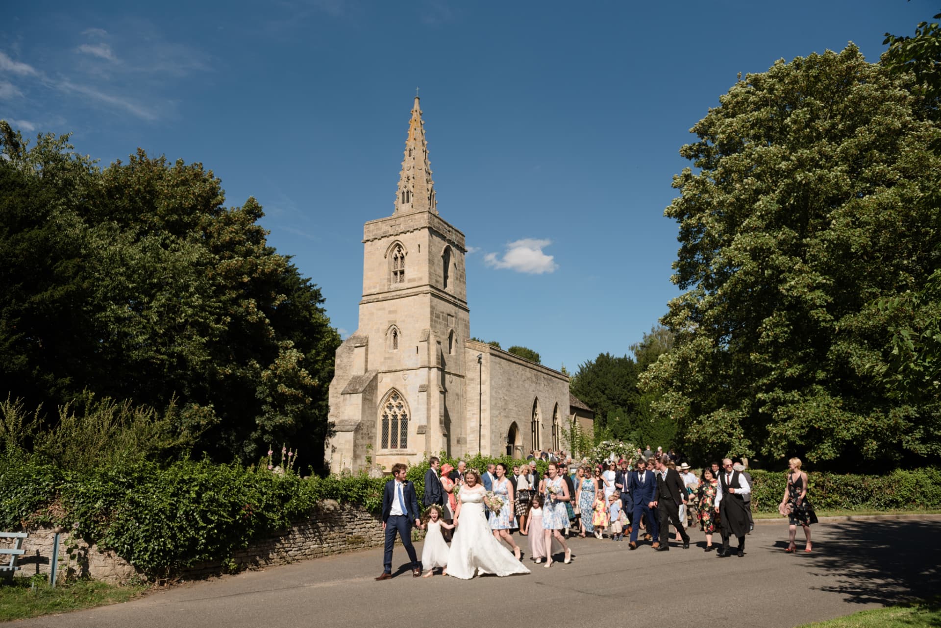 Bright blue sky behind couple leaving church