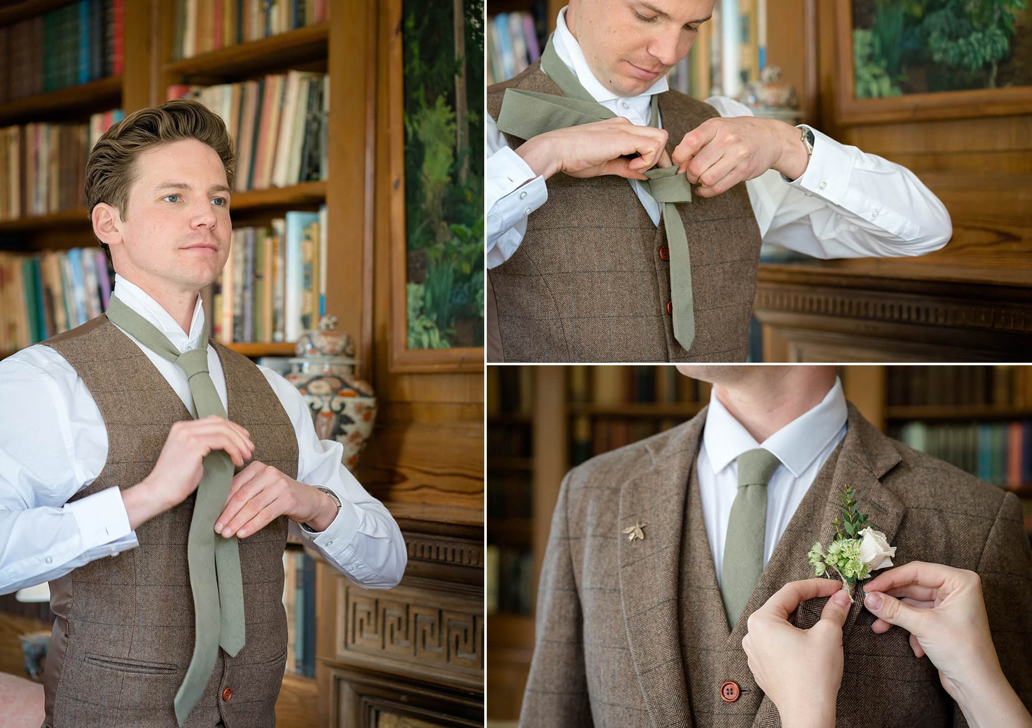 Groom putting on a pale green tie in front of a bookcase