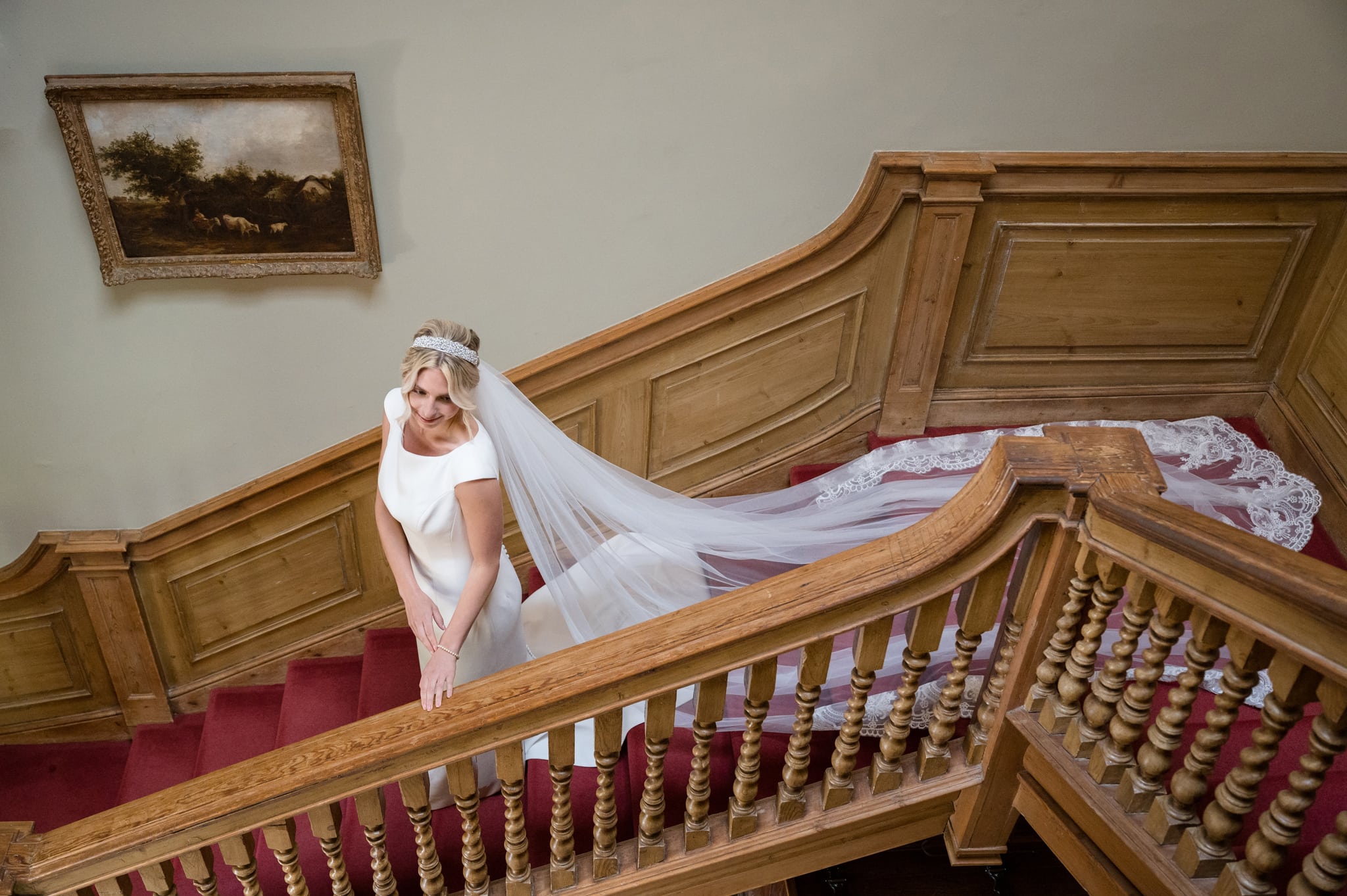Bride on the staircase at Sutton Bonington Hall