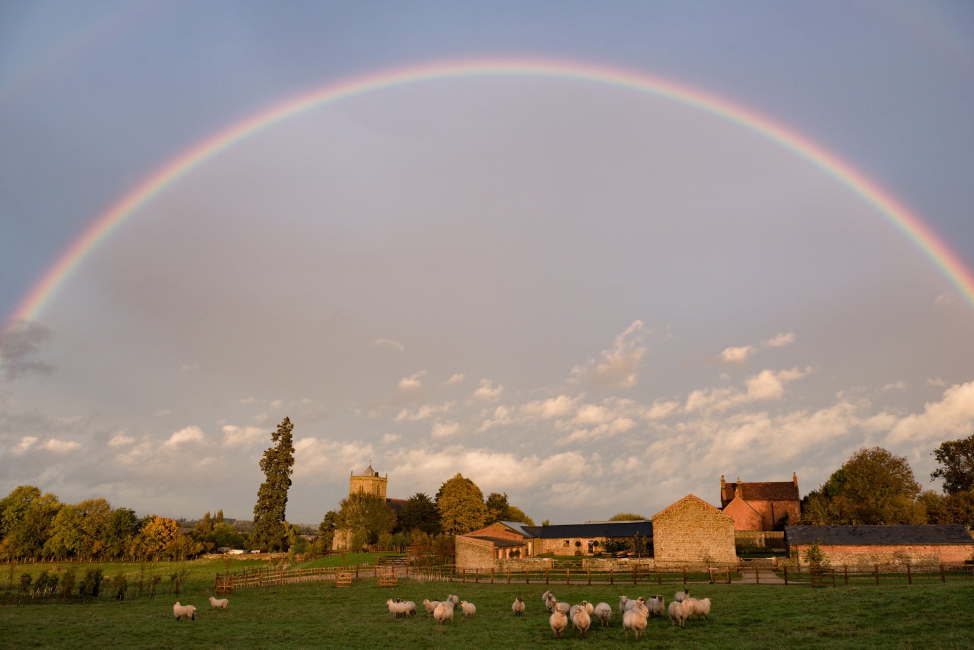 Rainbow over a barn wedding venue