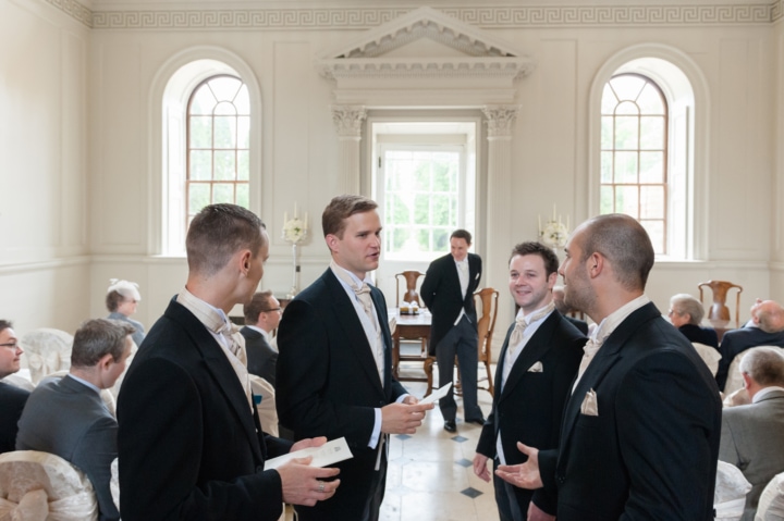 Groomsmen chatting to each other with the groom in the background