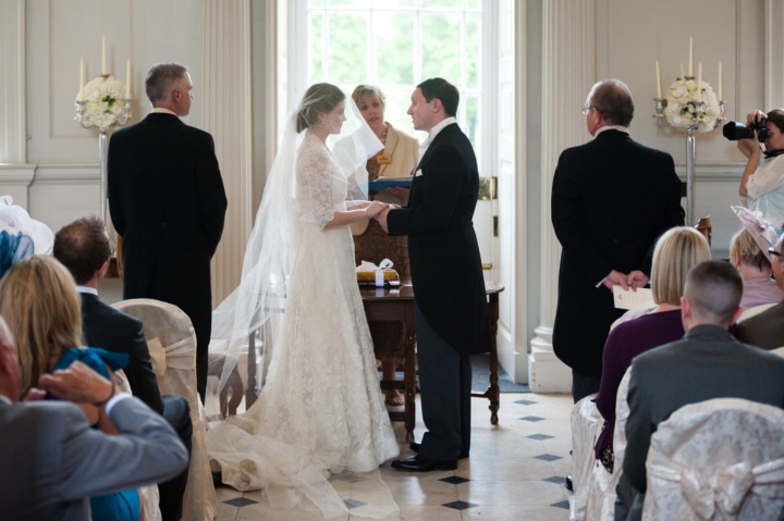 Bride and groom making marriage vows at Chicheley Hall