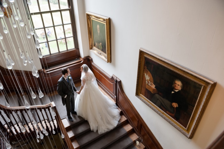 Portrait of bride and groom on the staircase at Chicheley Hall