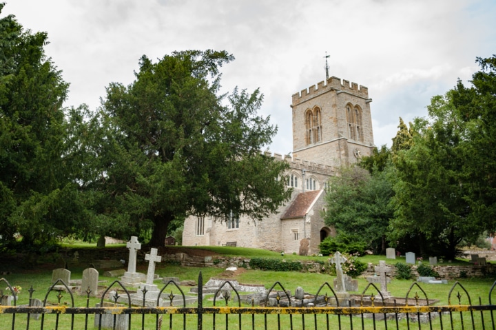 The outside of Chicheley church surrounded by trees