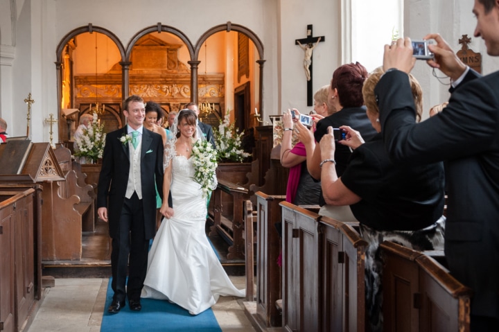 Bride and groom walking down aisle at Chicheley church