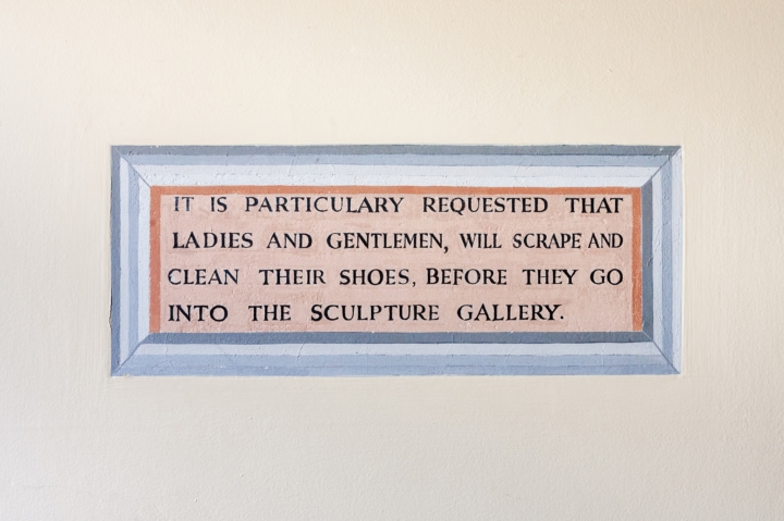 Sign asking 'It is particularly requested that ladies and gentlemen will scrape and clean their shoes before they go into the sculpture gallery'.