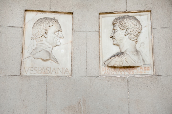 A pair of sculptures that look like postage stamps set into the wall