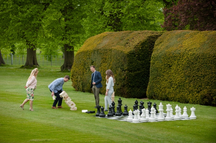 Wedding guests playing garden games on the lawn at Boughton House