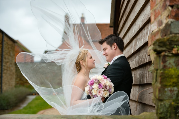 Bride's veil blowing in the wind at Dodford Manor