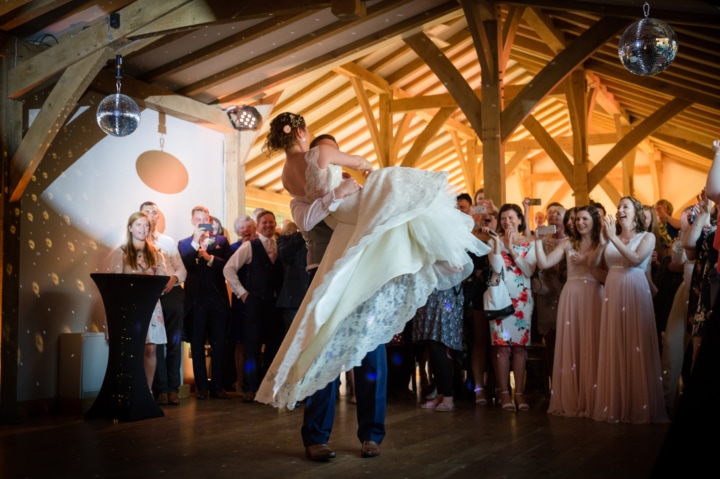 Bride being lifted and swirled around on the dancefloor at Dodford Manor