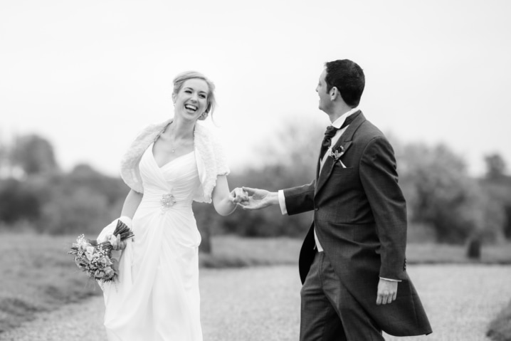 Bride and groom laughing in the grounds of Dodford Manor