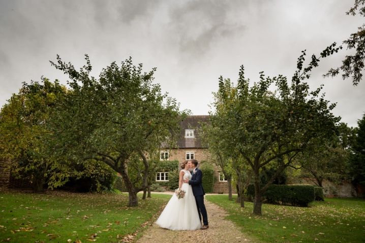 Couple in front of the farmhouse at Dodmoor House