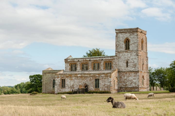 St Mary's church in Fawsley with sheep in the foreground